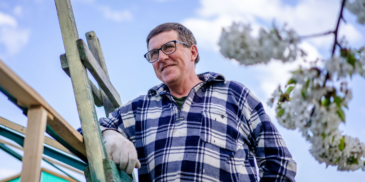 Man on an allotment thinking